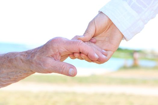 Senior women holding hands with caretaker 