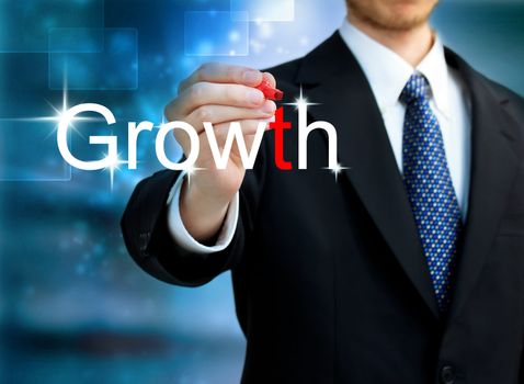  Young business man writing the word Growth with red pen 