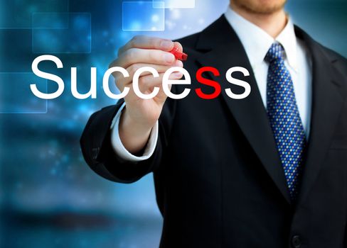  Young business man writing the word Success with red pen 