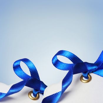 Price Tags with Blue Ribbons on Light Blue Background