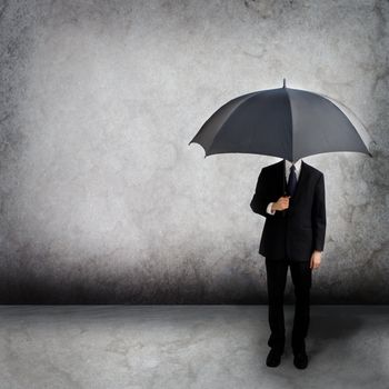 Business man holding an umbrella 