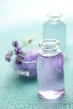 Aromatherapy oil and lavender on light blue background