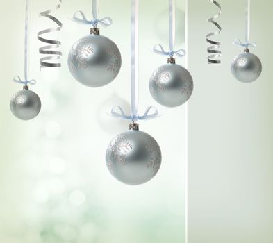 Silver Christmas Ornaments over glowing background