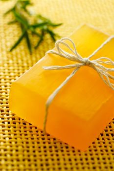 Handmade golden yellow colored soap with rosemary