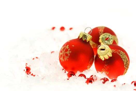  Red Christmas ornaments on snow