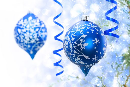 Christmas blue ornaments over bokeh lights background