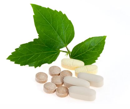 Natural pills with green leaves