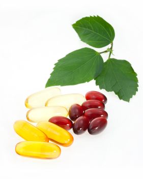 Fish oil capsules with green leaves