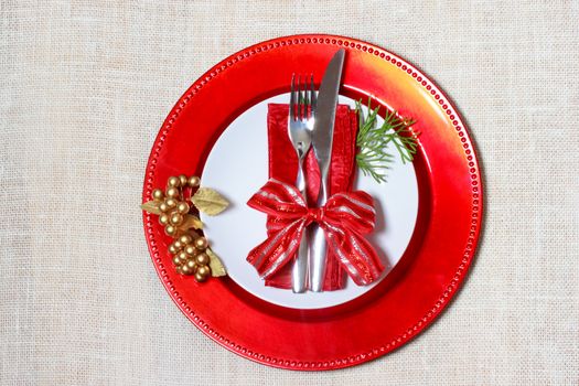 Christmas plates and silverware on burlap