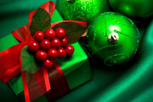 Christmas green gift box with ornaments on silky  cloth