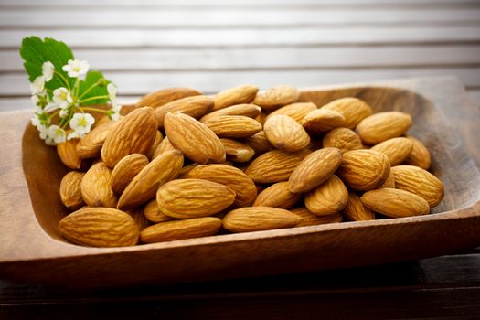 Almonds in wooden plate