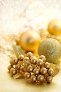 Christmas gold color ornaments over shiny background