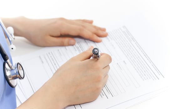 Female doctor doing paper work over white background