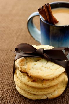 Cookies and coffee with cinnamon sticks