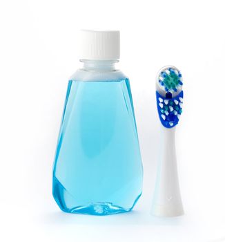 Mouthwash and toothbrush isolated on white background