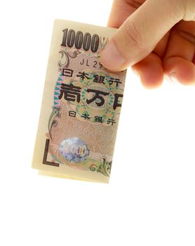 Hand holding Japanese ten thousand yen on white background