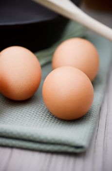 Fresh eggs with black cast iron pan