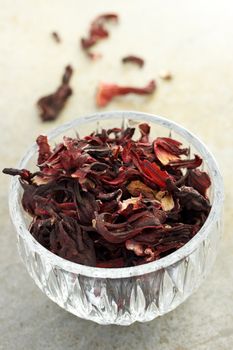 Dried hibiscus tea in glass cup