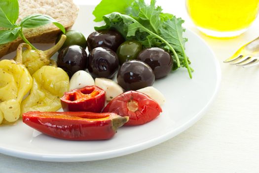 Pickled peppers and olives on white dish