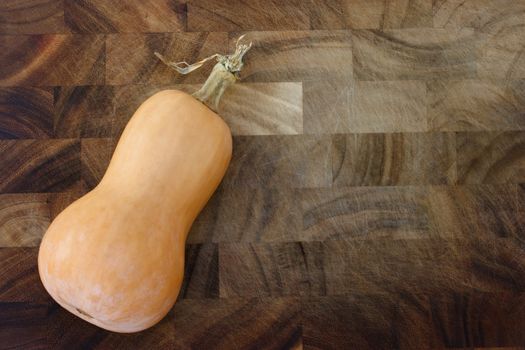 Butter nut squash on wooden cutting board