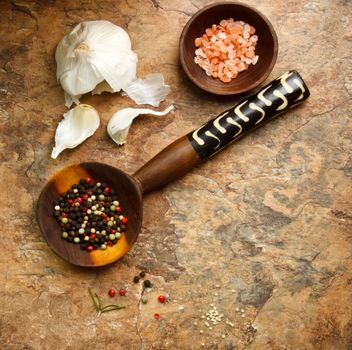 Rustic image of peppercorn, garlic and sea salt 
