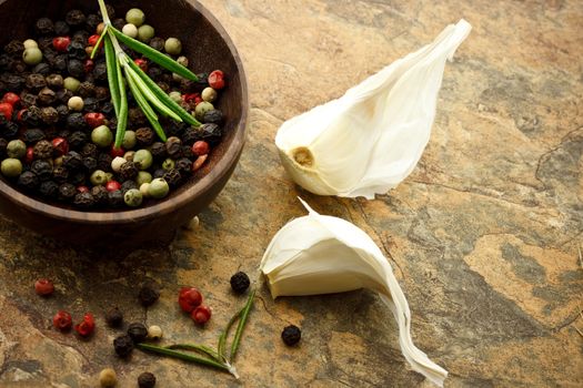 Peppercorn and garlic on stone table