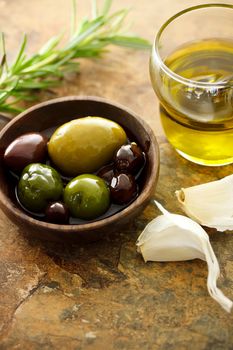 Olive oil and mixed olives with garlic cloves
