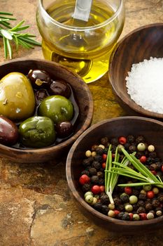 Olive oil, peppercorn, sea salt on stone table