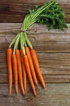 Organic carrots on wood