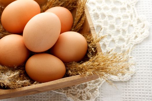 brown eggs in wooden bowl