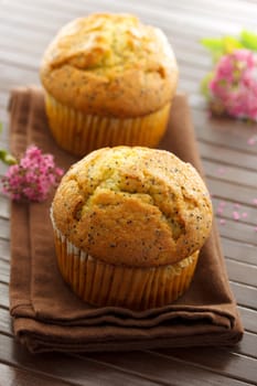 Delicious poppy seed muffins with pink small flowers