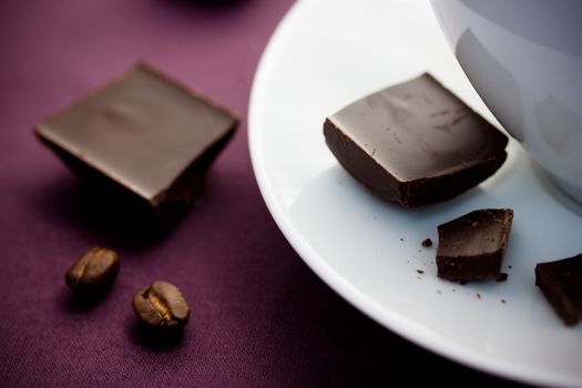 Chocolate with coffee cup on violet tablecloth