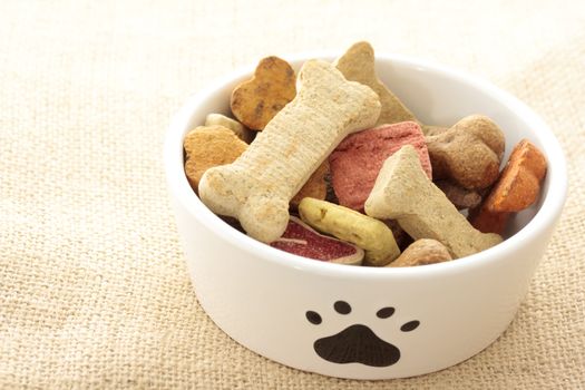 Dog food in bowl on burlap cloth
