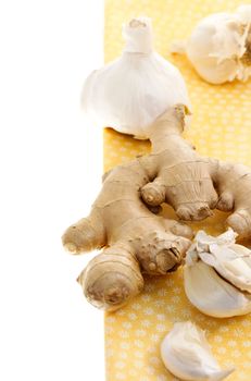 Ginger and garlic on yellow tablecloth