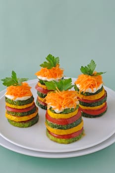 Pinnacles of yellow and green zucchini with tomato