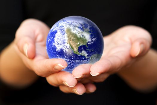 human hands carefully holding Earth planet. Glass World