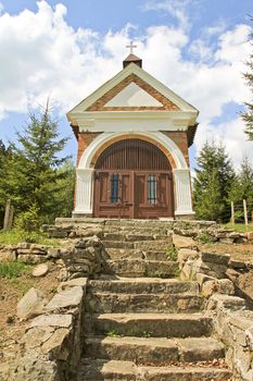 A little chapel standing in the forest