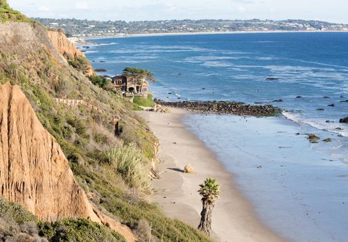 Modern houses overlook ocean and waves by La Piedra state beach in Malibu California