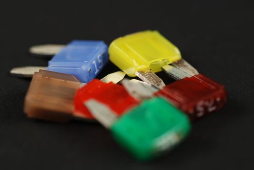 electrical automobile fuses with shallow depth of field on black background