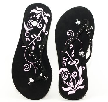 Beautiful women's black flip-flops isolated on white background