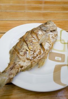 Fried fish on white dish, delicious thai food
