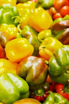 Many Color Bell Peppers at the farmers market with sharp focus on center vegetables