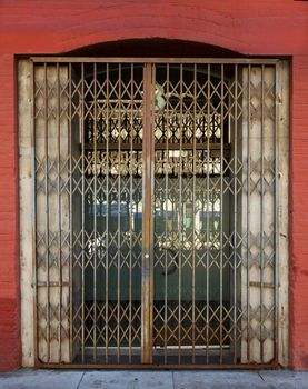 Old Steel Security Gate on door to red brick building