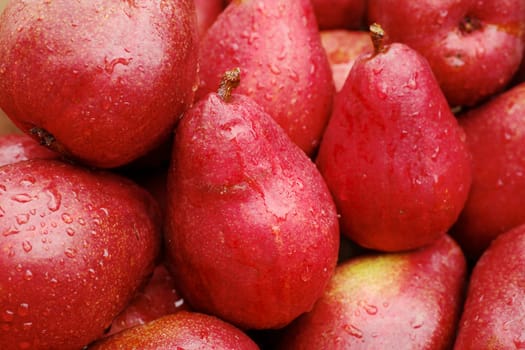 Pile of red pears at the farmers market on a rainy day