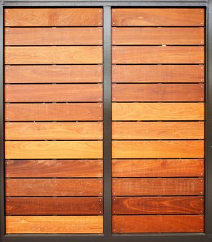 Stained wood framed in steel garage doors vertical