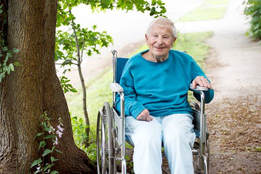 Senior Women in a Wheelchair Smiling Outside