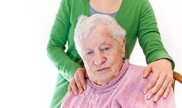 Senior and young woman together on white background