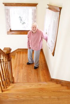 Senior woman in front of staircase in day time