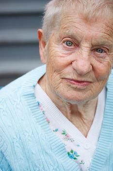 Portrait of senior lady in front of staircase