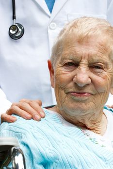 Senior lady in wheelchair with her doctor